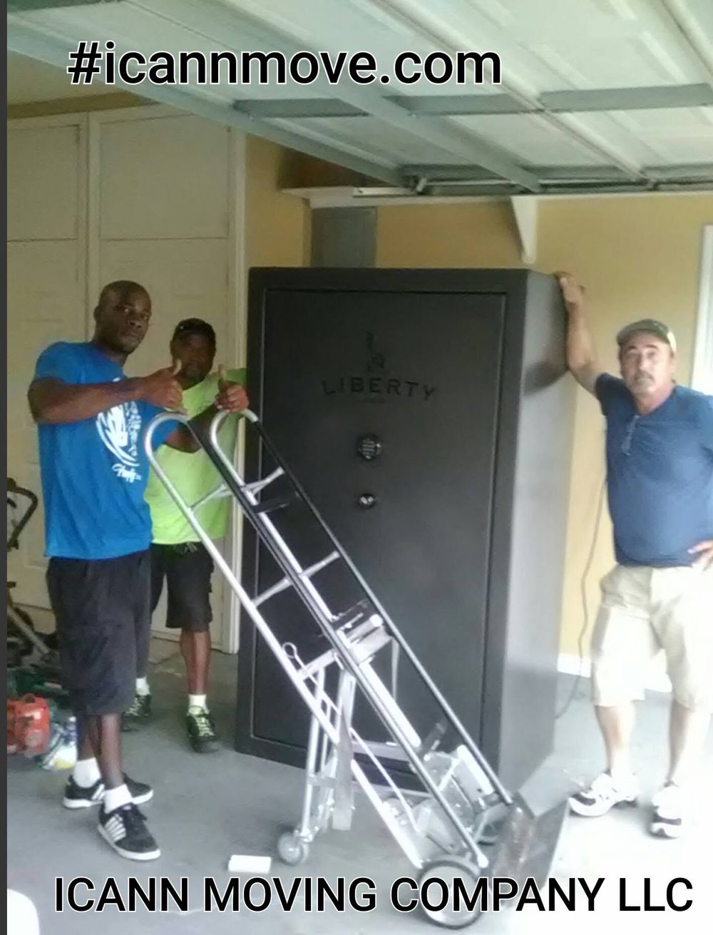 Three ICANN movers with a Liberty gun safe on a safe dolly in a garage